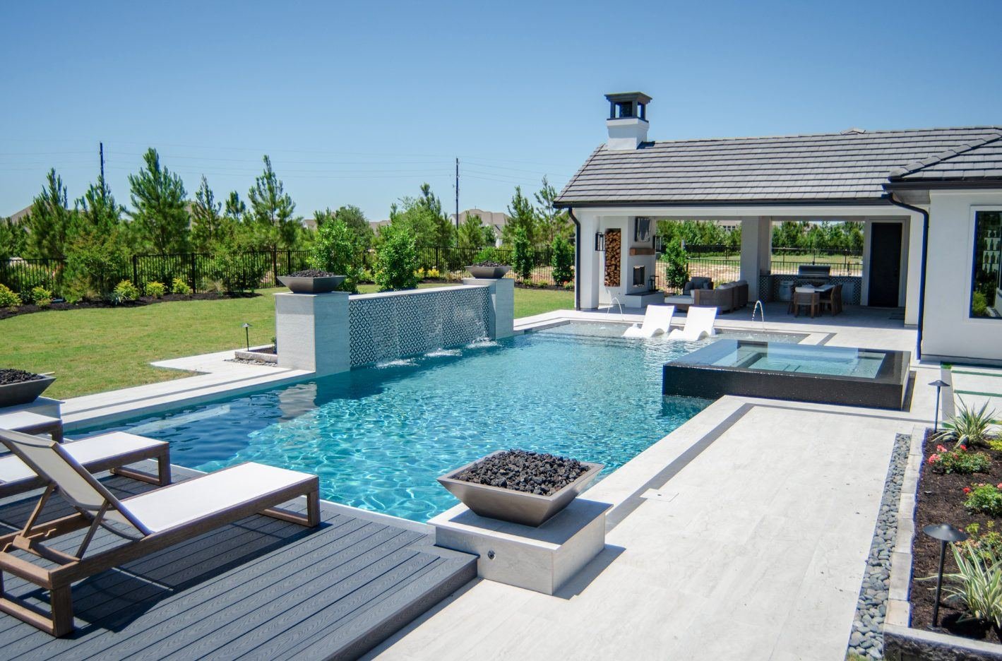 Custom pool with a firepit and water feature