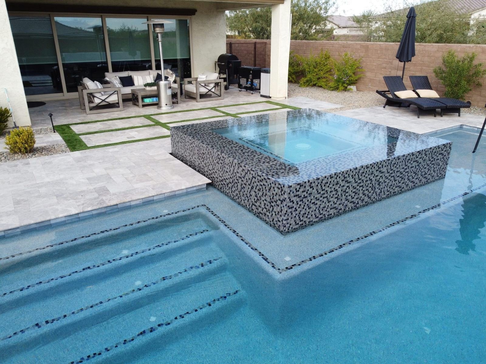 Custom pool with a mosaic spa